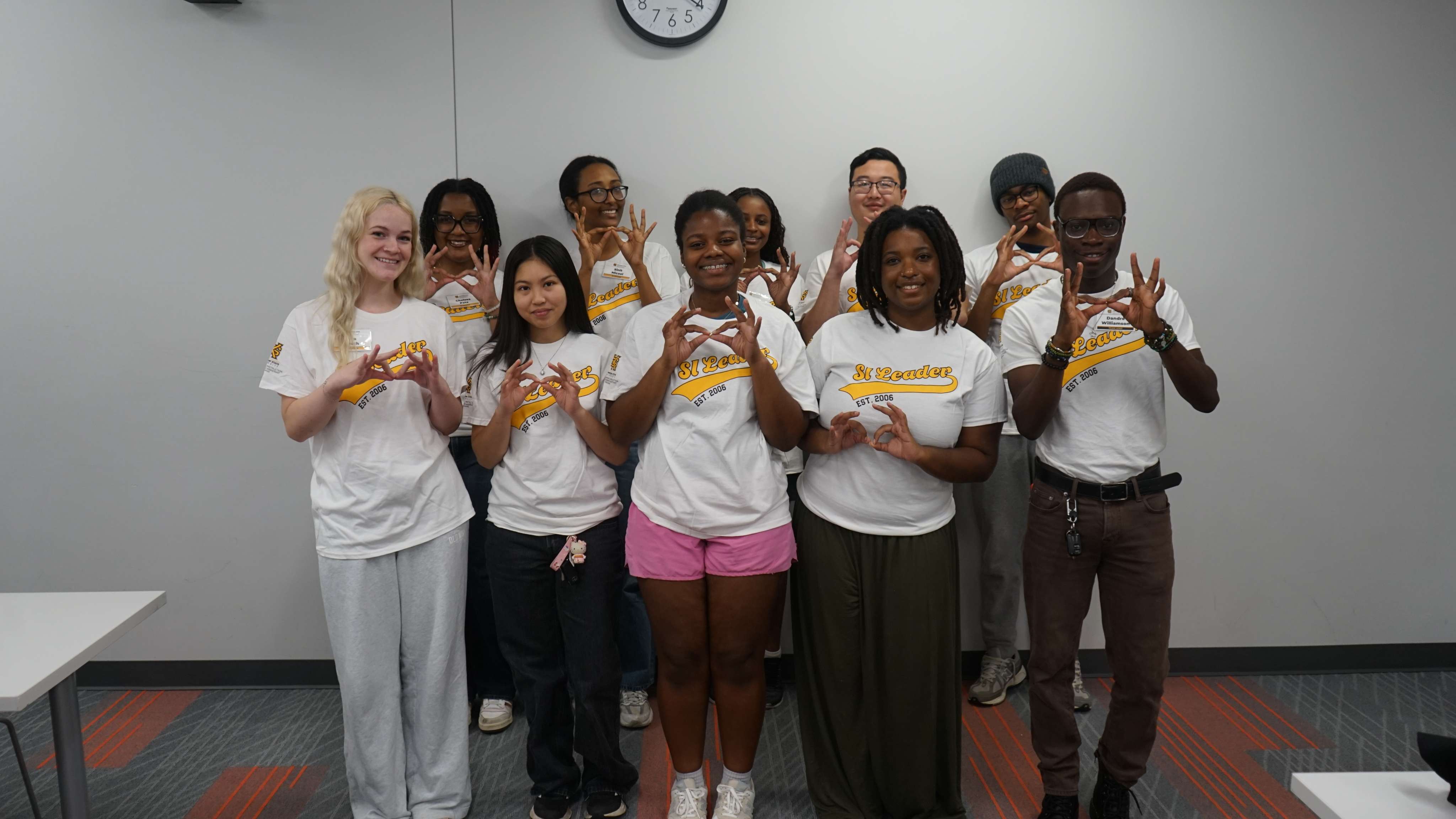 SI Leaders holding up the owl eyes hand sign.
