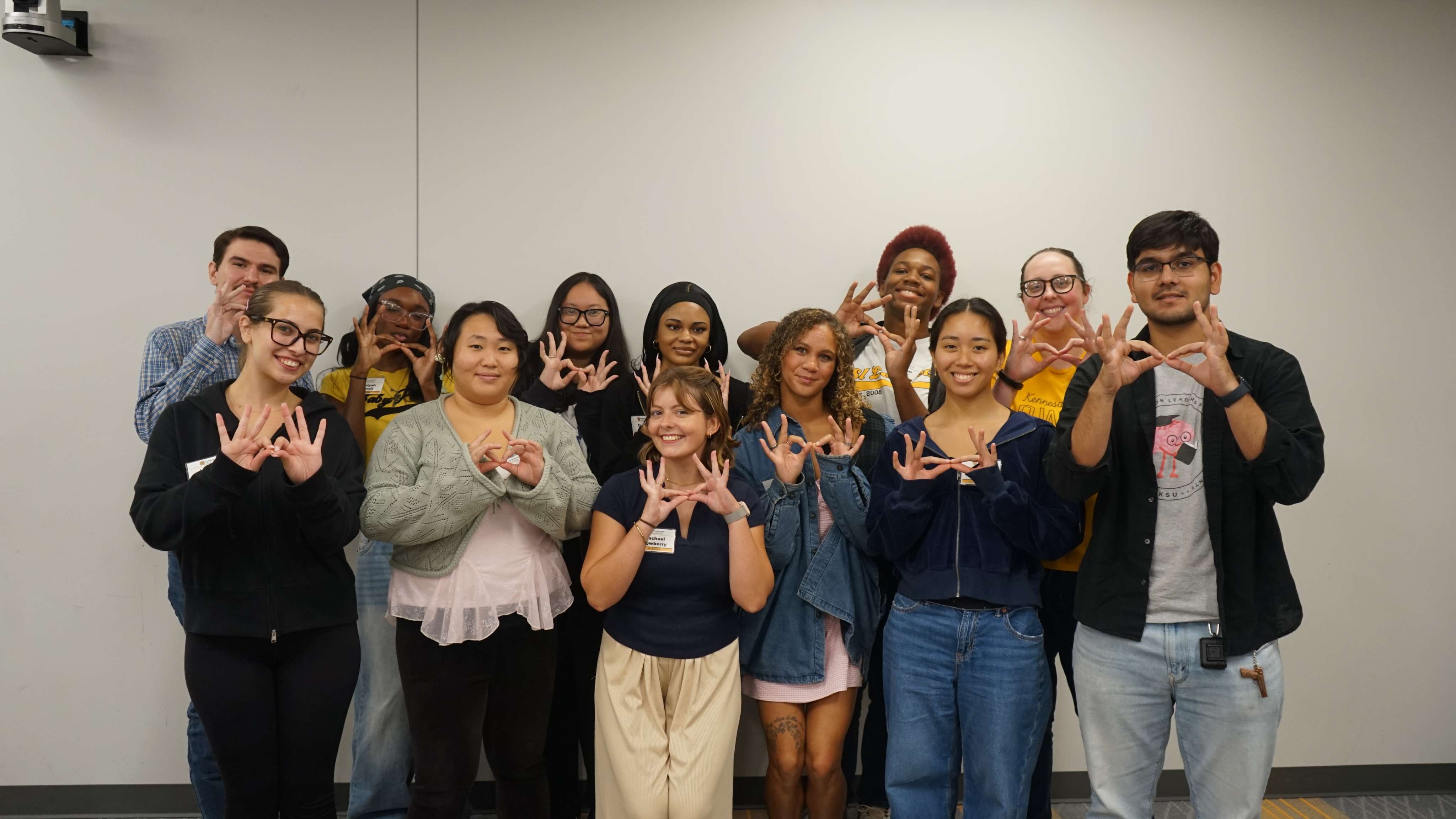SI Leaders holding up owl eyes