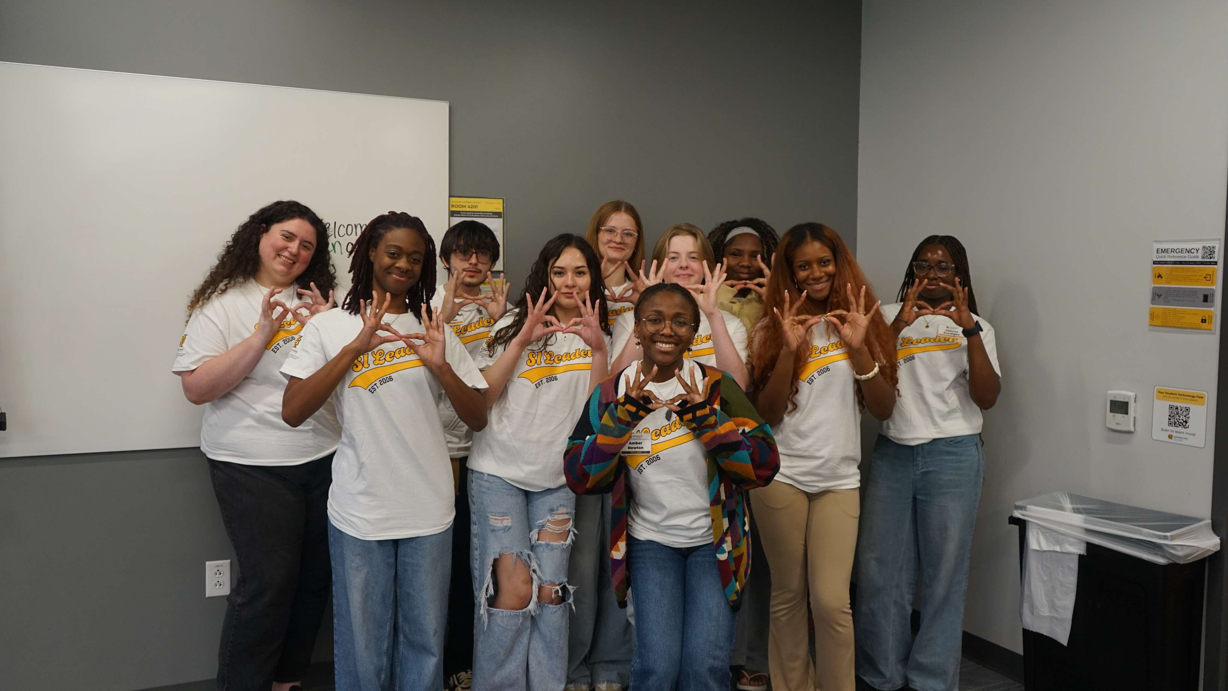 SI Leaders holding up owl eyes.