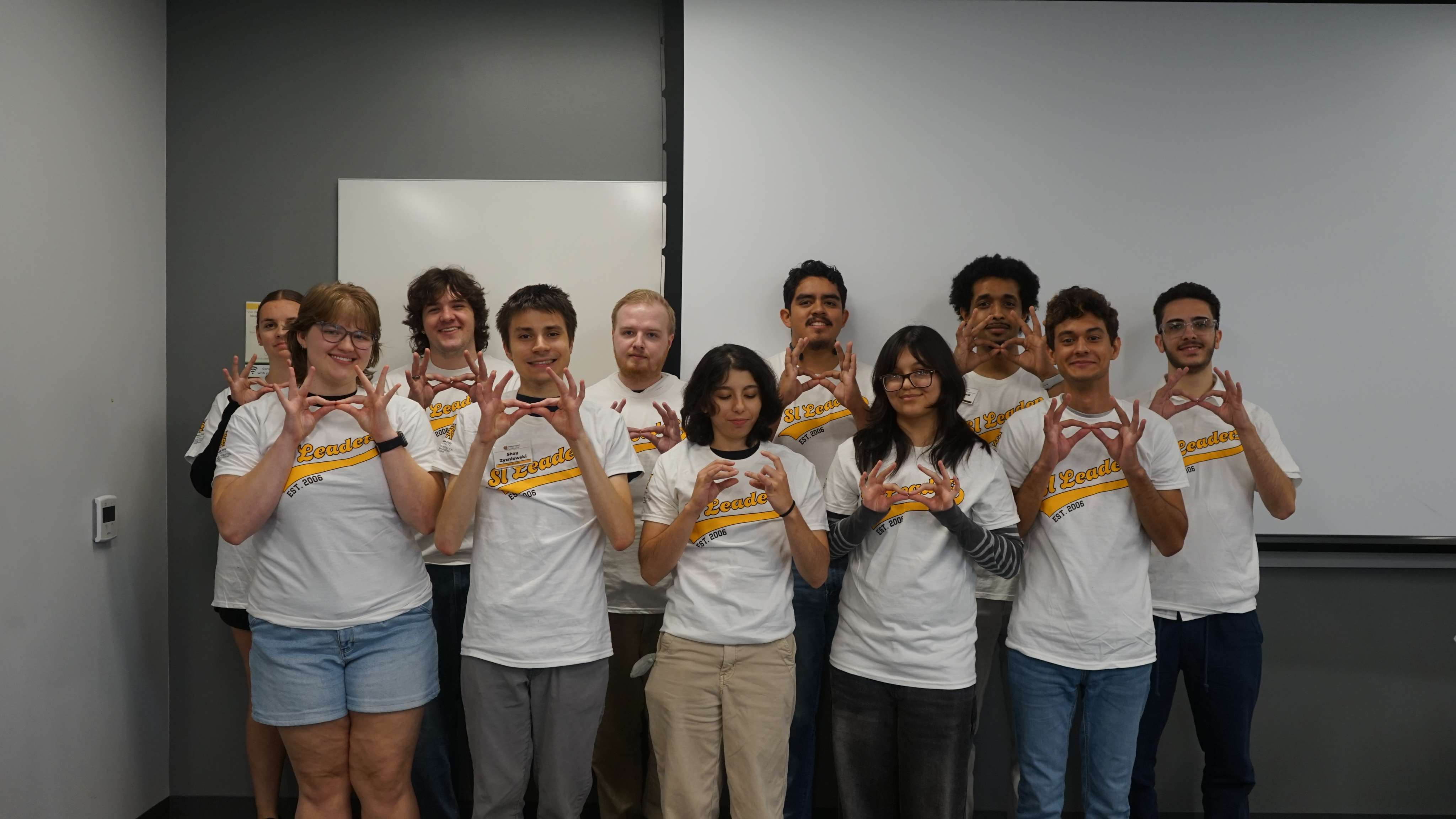 SI Leaders holding up owl eyes