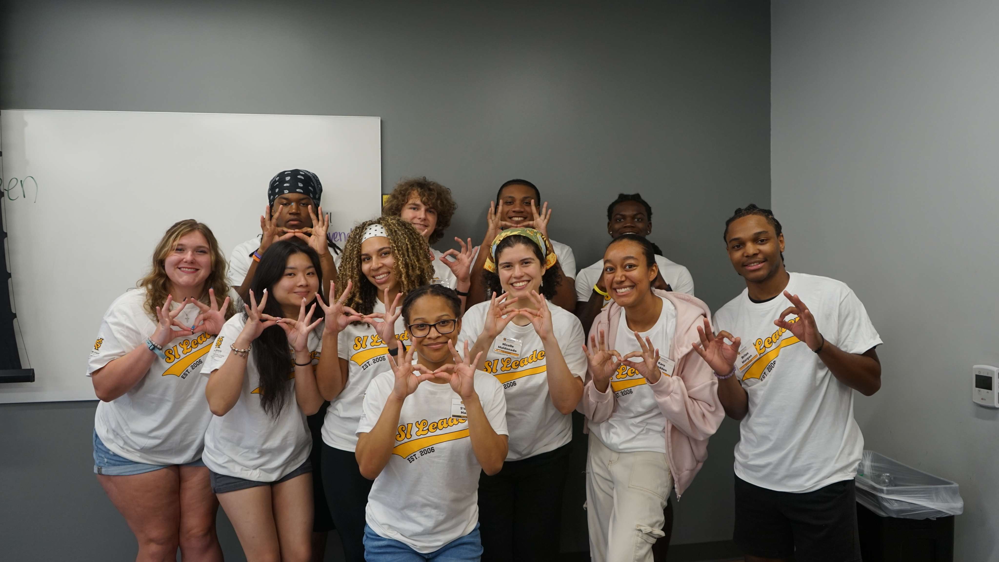 SI Leaders holding up owl eyes.