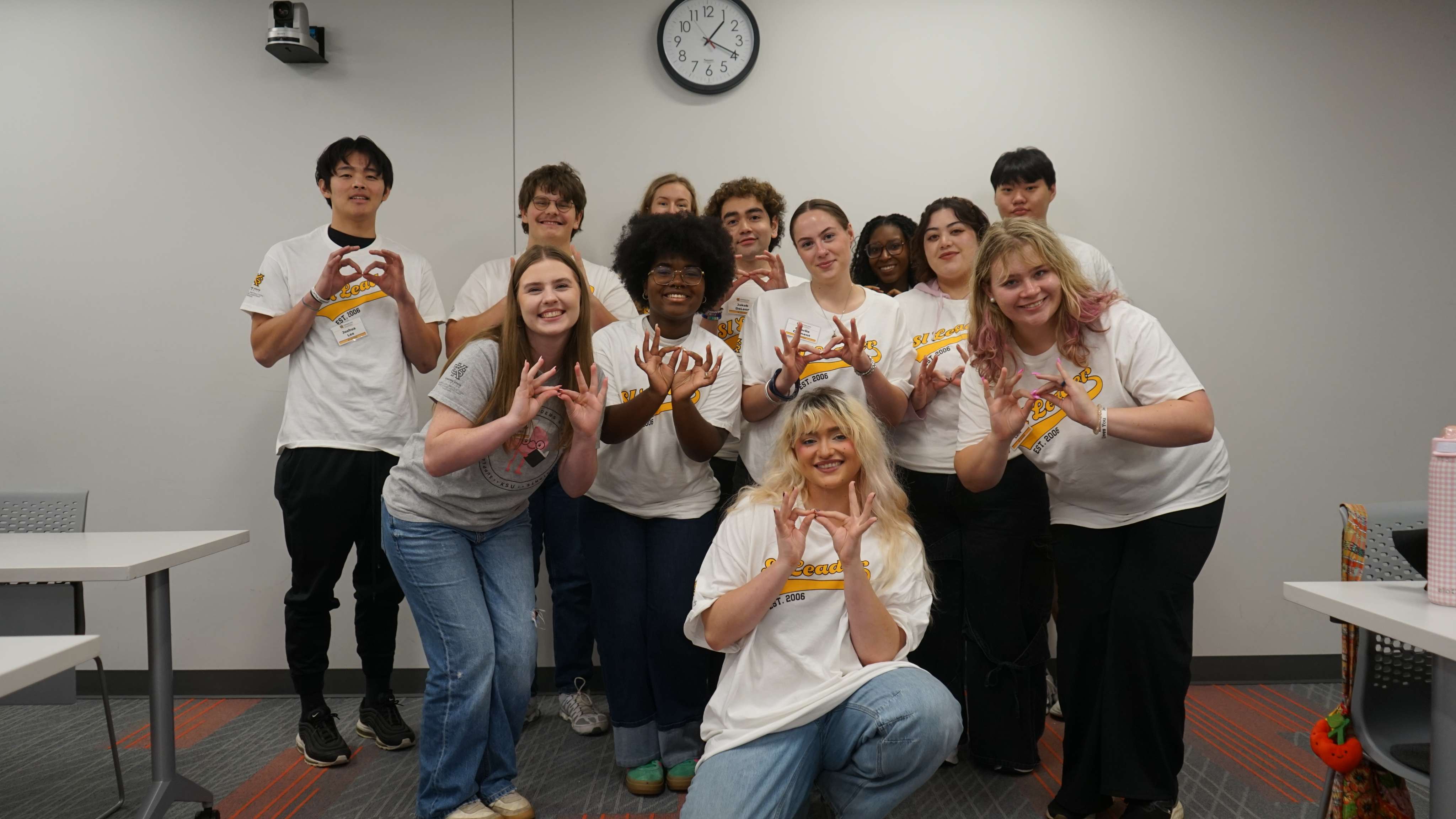 SI Leaders holding up owl eyes.