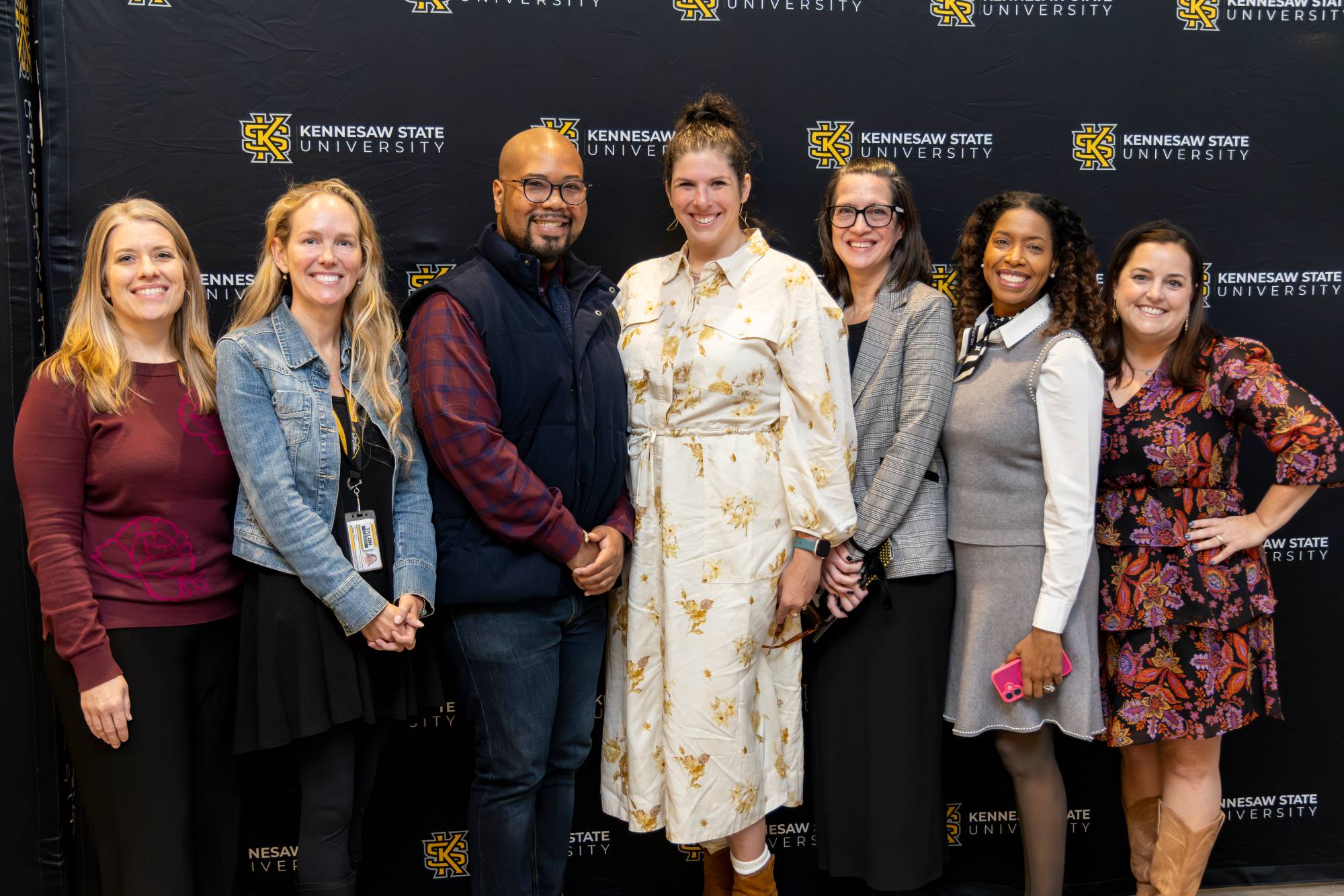 faculty and staff members at KSU smiling together after receiving recognition at the 2025 Celebration of Teaching
