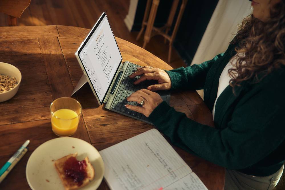 person typing on a laptop with a generative ai website open