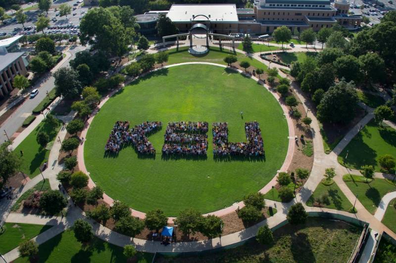 aerial view of students on the KSU campus green organized to spell KSU with the large number of students