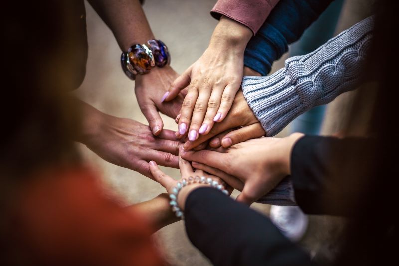 image of hands touching in a circle
