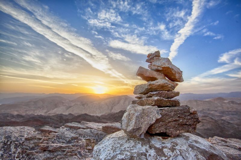 image of mountain, sun, and balancing rocks