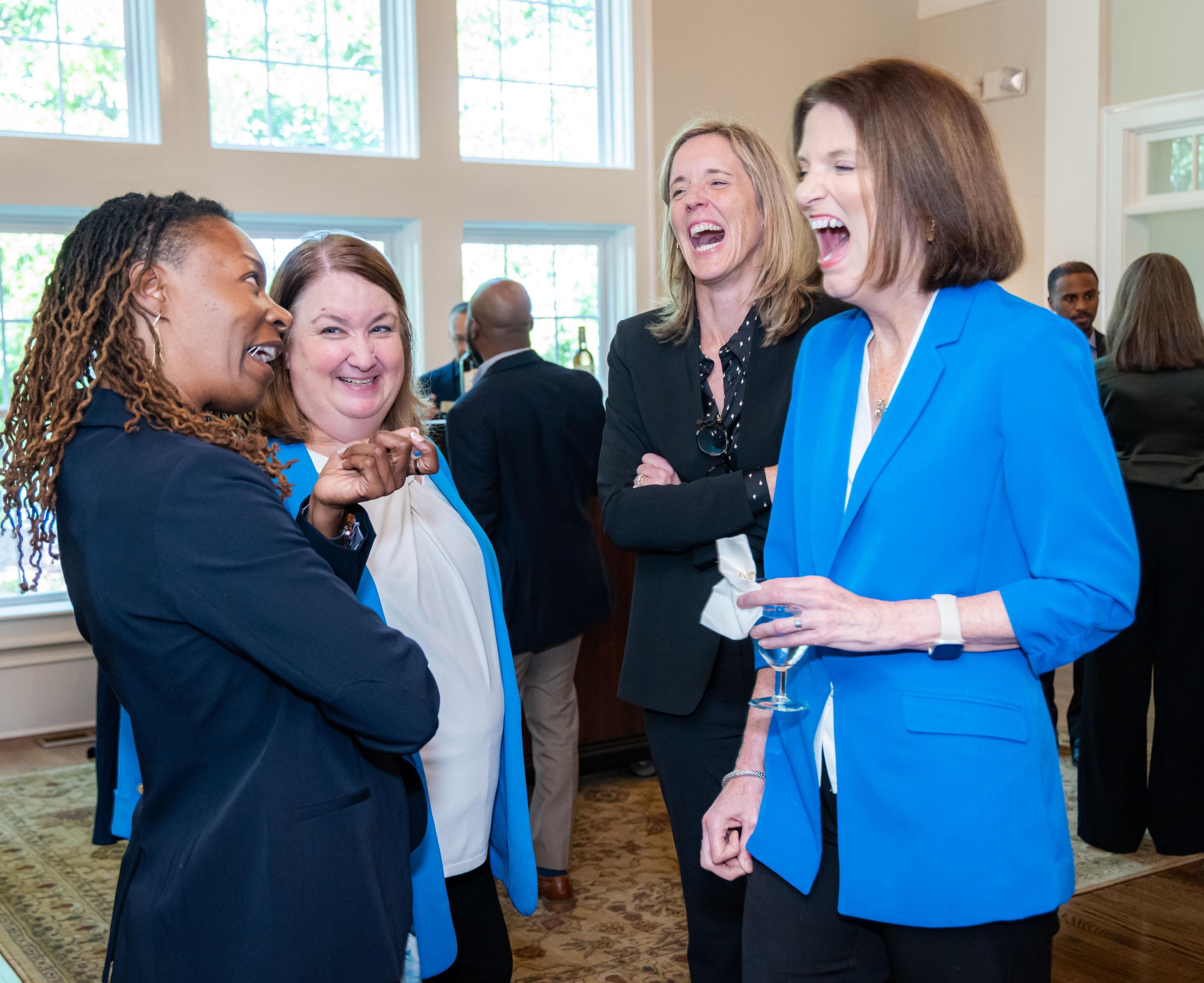  / president, kathy schwaig laughing with guests 