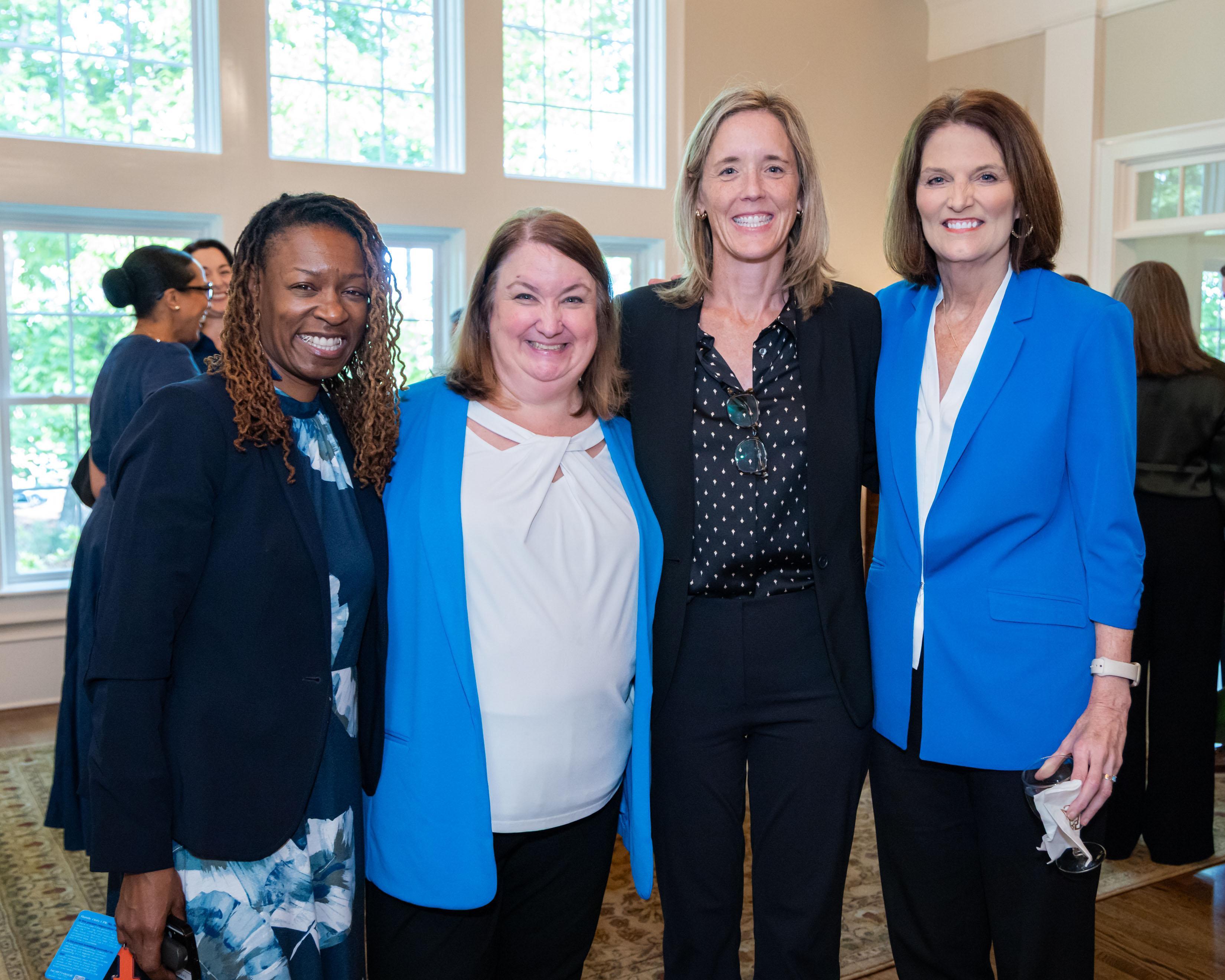  / president, kathy schwaig posing with guests 