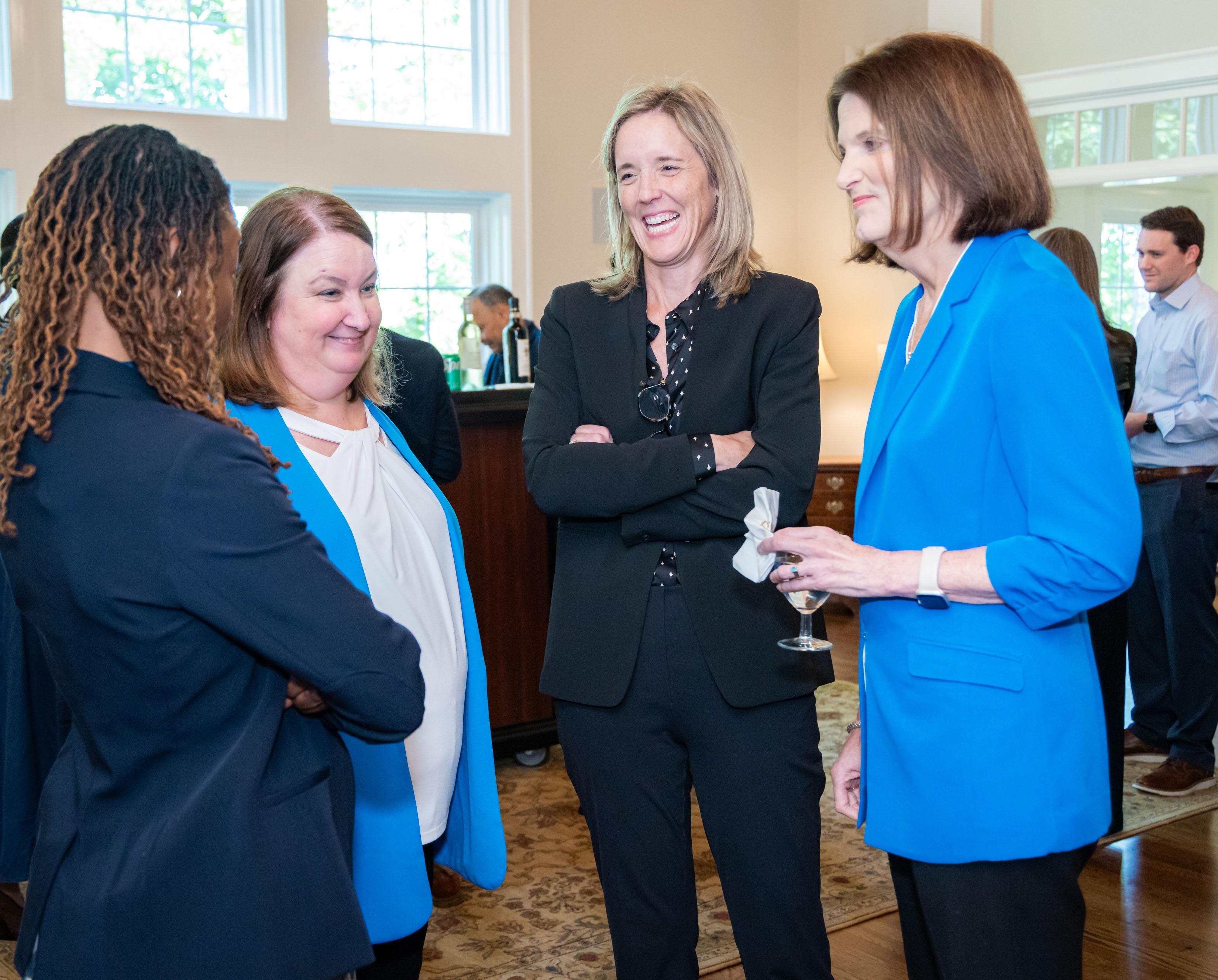  / president, kathy schwaig posing with guests 