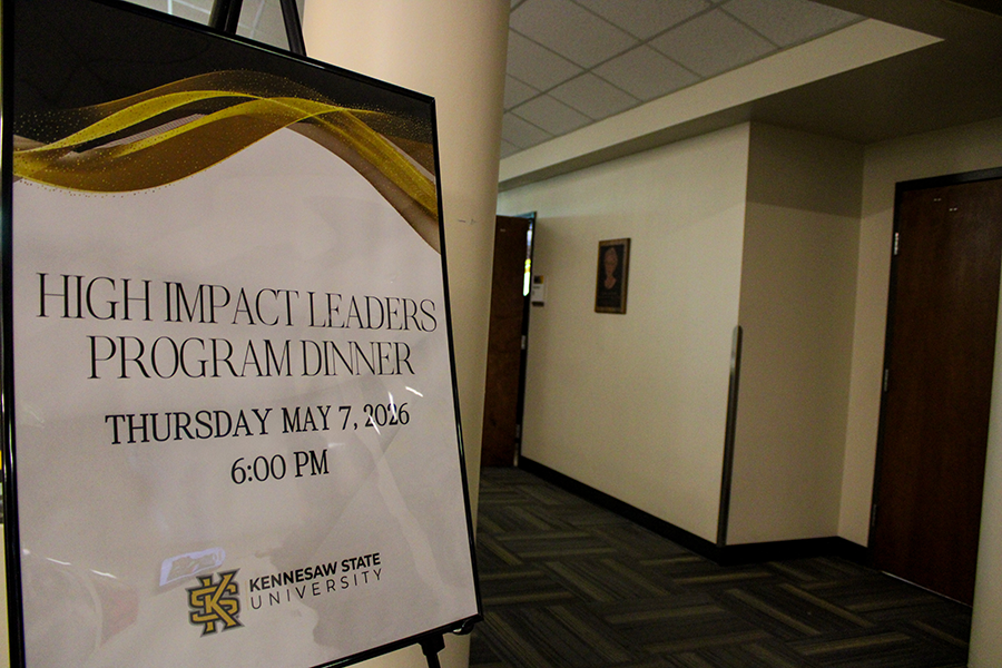 HILP Dinner 2025-2026 / Sign in a hallway for "High Impact Leaders Program Dinner" at Kennesaw State University, scheduled for May 7, 2026, at 6:00 PM.