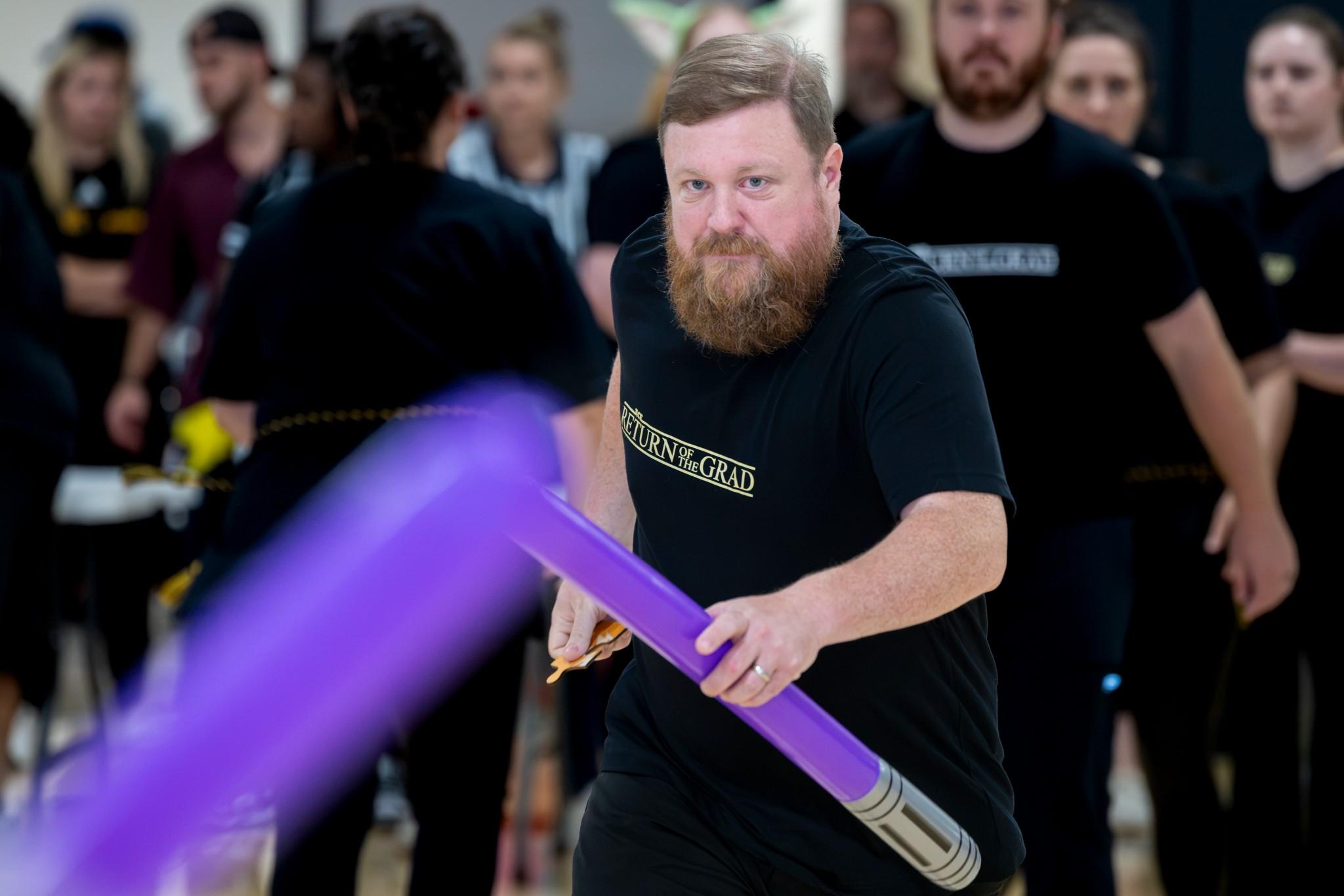 2026 Owlympics / man battles with a purple light saber in Owlympics game