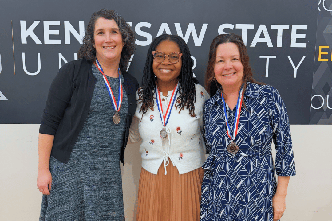 3rd place marietta trivia team smiling and wearing their bronze medals