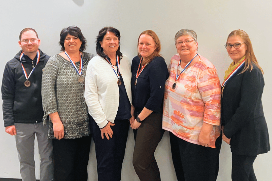 3rd place winners smiling wearing bronze medals