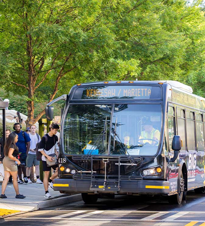 ksu students getting on the big owl bus.
