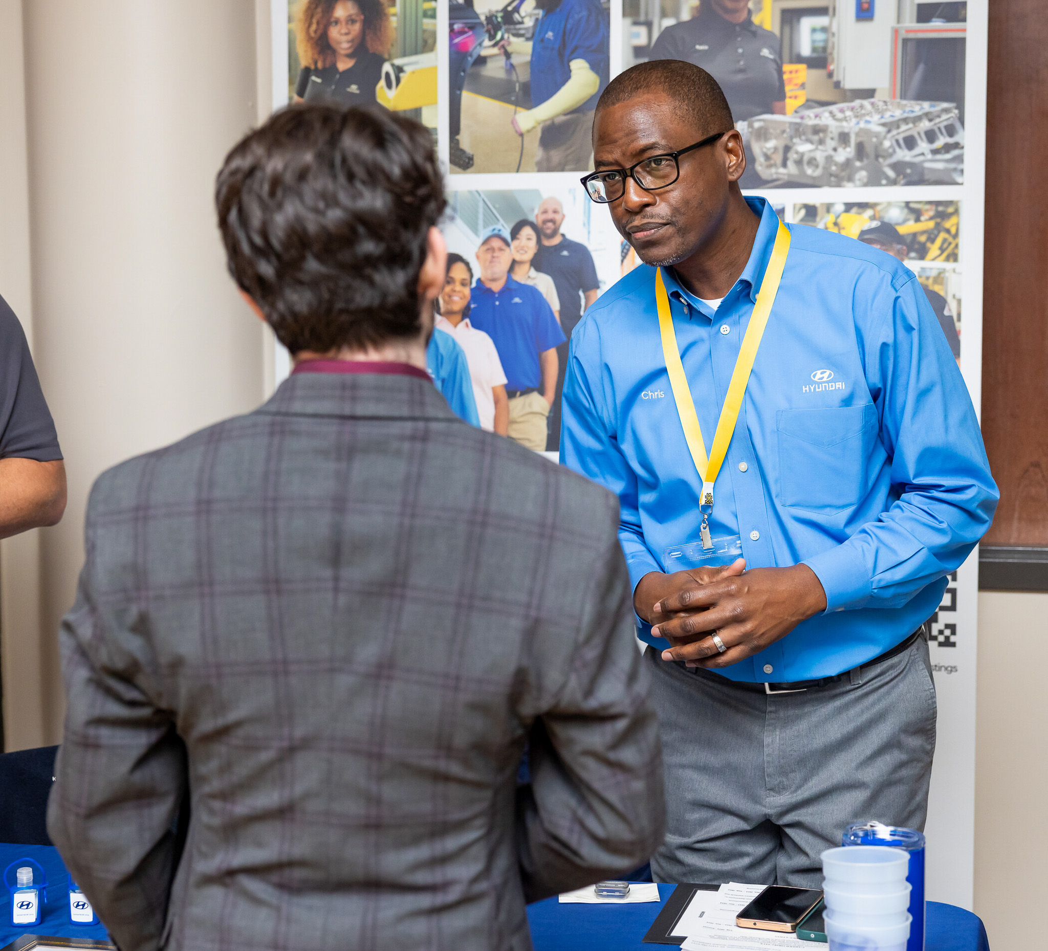 employer talking to student at job fair
