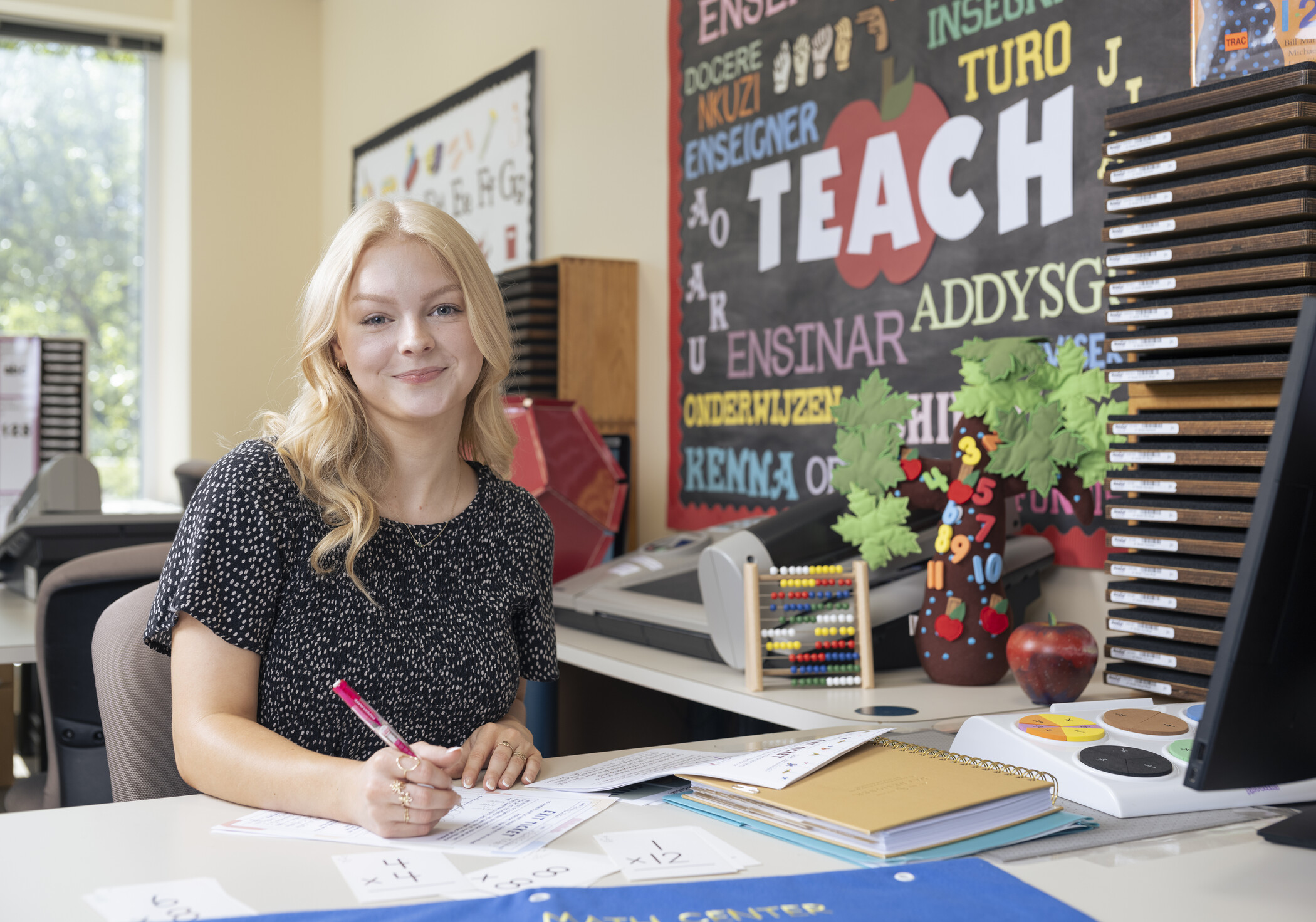 a student teacher works at her desk