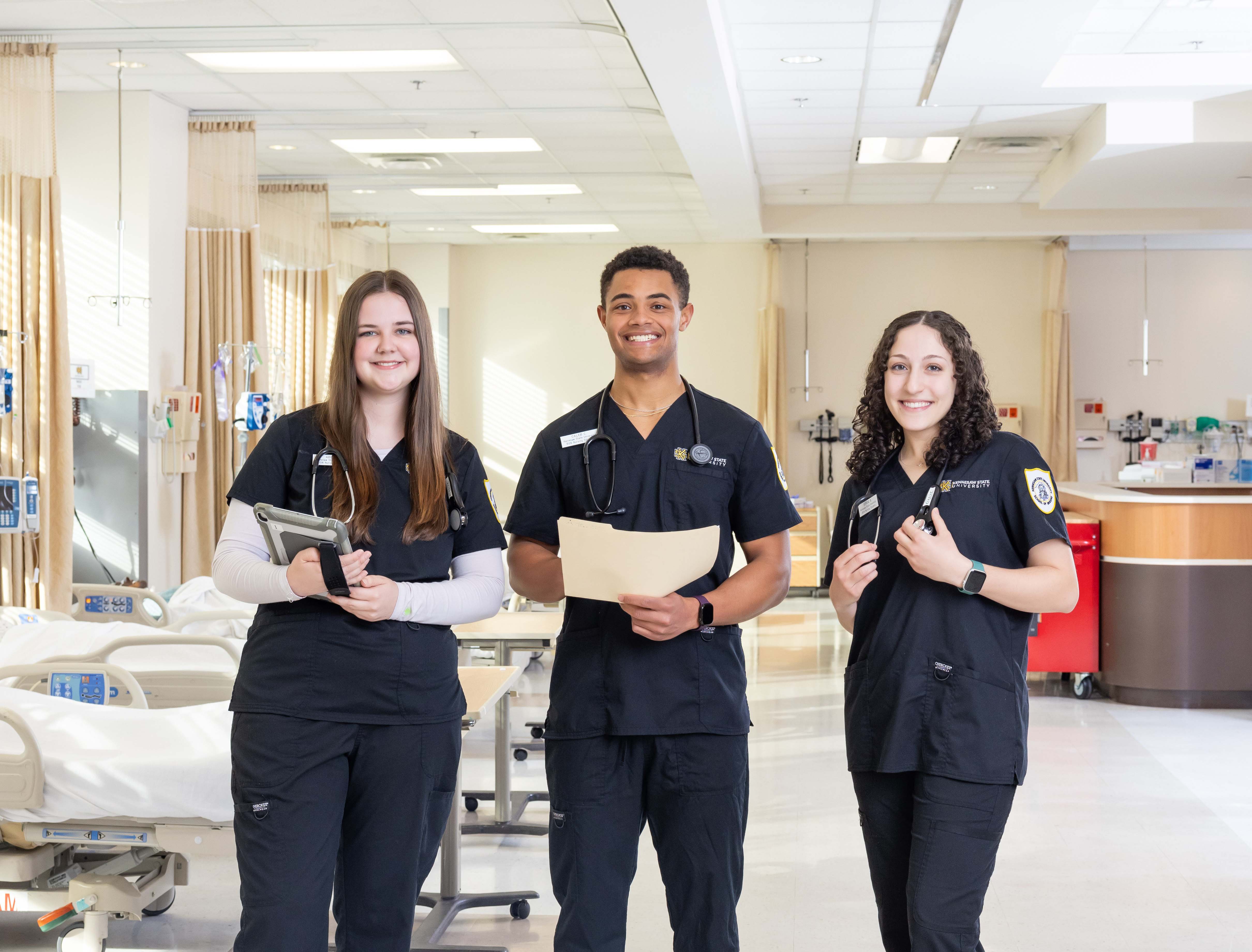 Two healthcare students pose during a practical