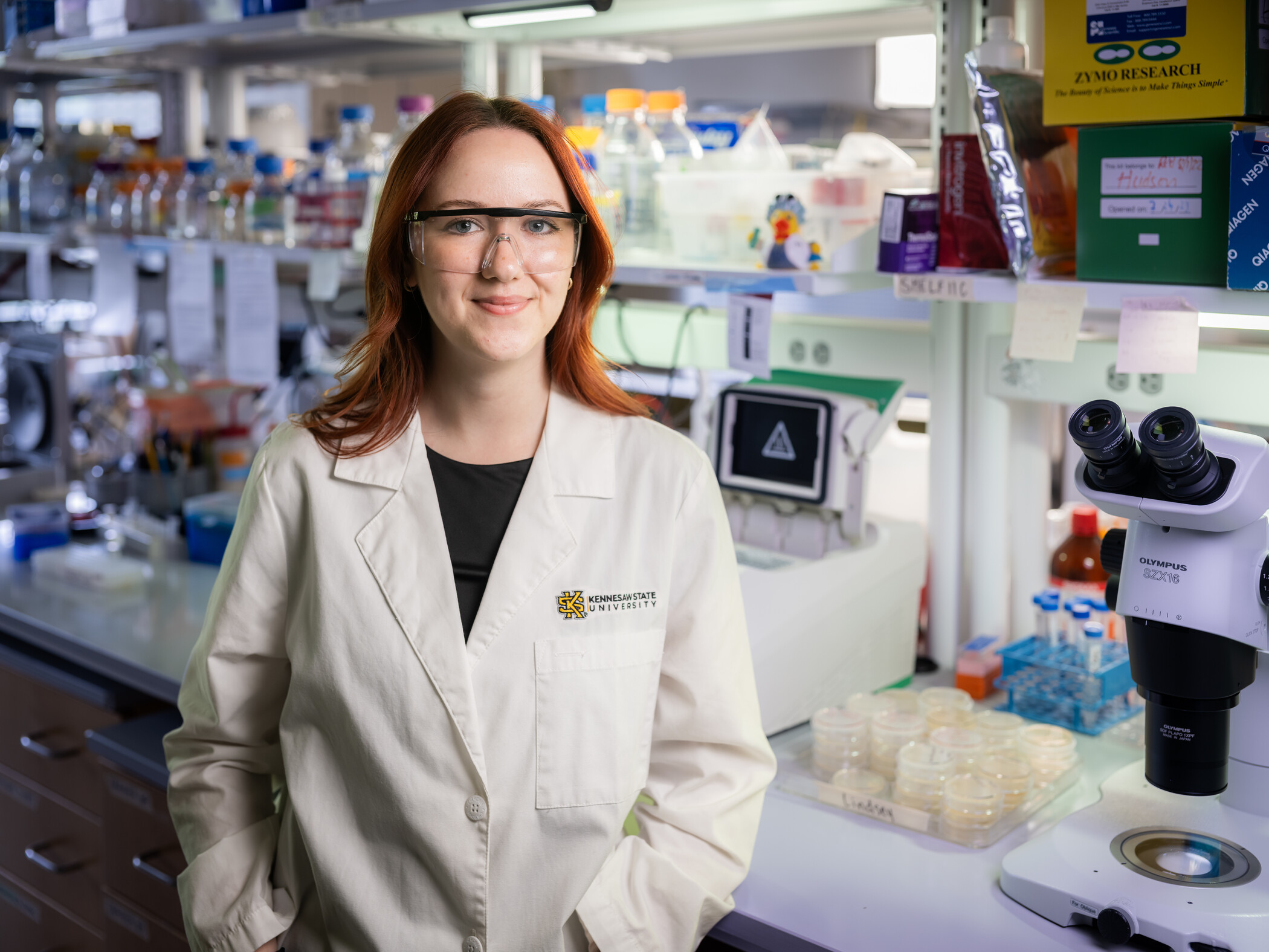a science student poses with her lab equipment