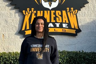 Maya Phillips standing in front of KSU sign.