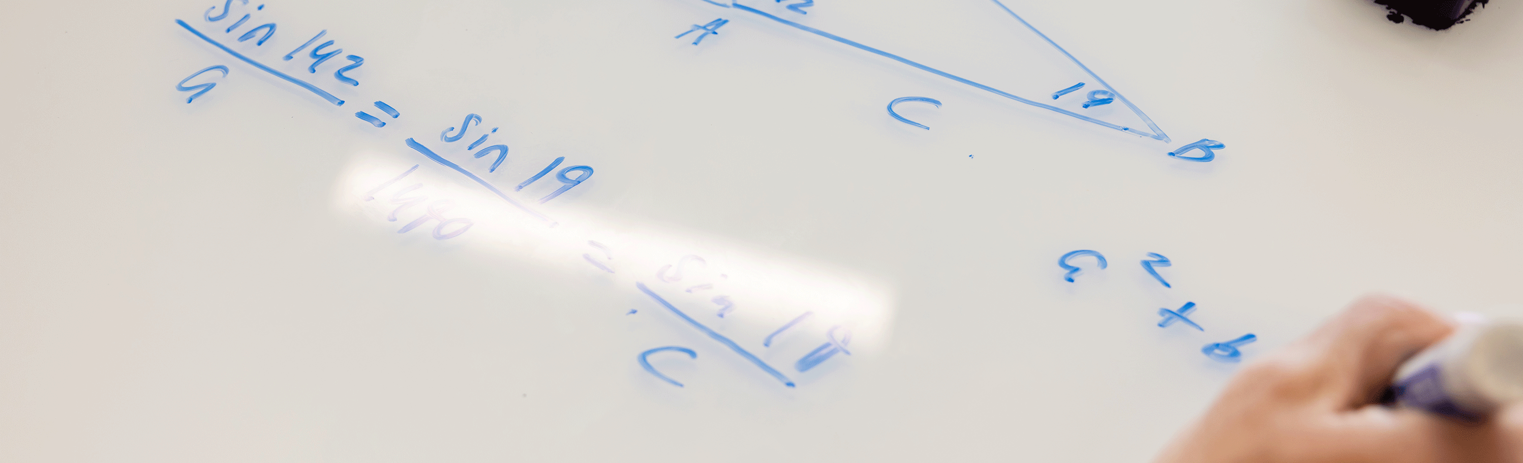 a trigonometry problem written on a dry erase desk in the Smart Center