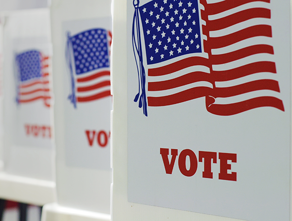 Voting booths with the america flag and the word vote