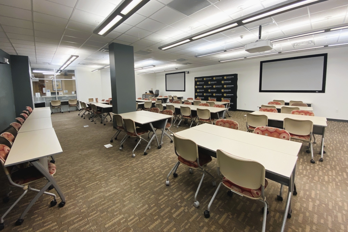 a room with several groups of tables and chairs