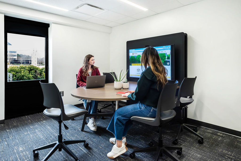 carmichael student center welcome center study room with students reviewing on a wall mounted television