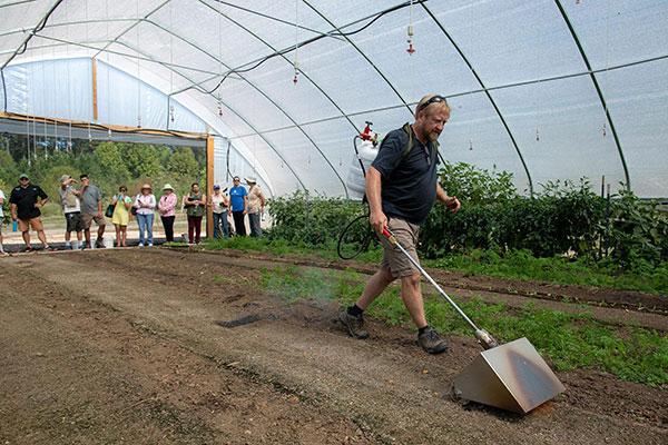 Small Farm Tools Demonstration Day  / KSU Field Station operations manager Michael Blackwell demonstrates flame weeding.