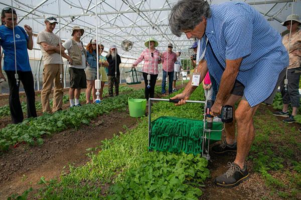 Small Farm Tools Demonstration Day  / 
KSU Field Station operations manager Michael Blackwell, left, and assistant manager Luke Miller demonstrates power harrow using a walk behind tractor. 