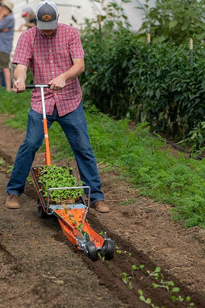 Small Farm Tools Demonstration Day  / Blake Thaxton of Johnny’s Selected Seeds demonstrates a Terrateck Paperpot Transplanter.