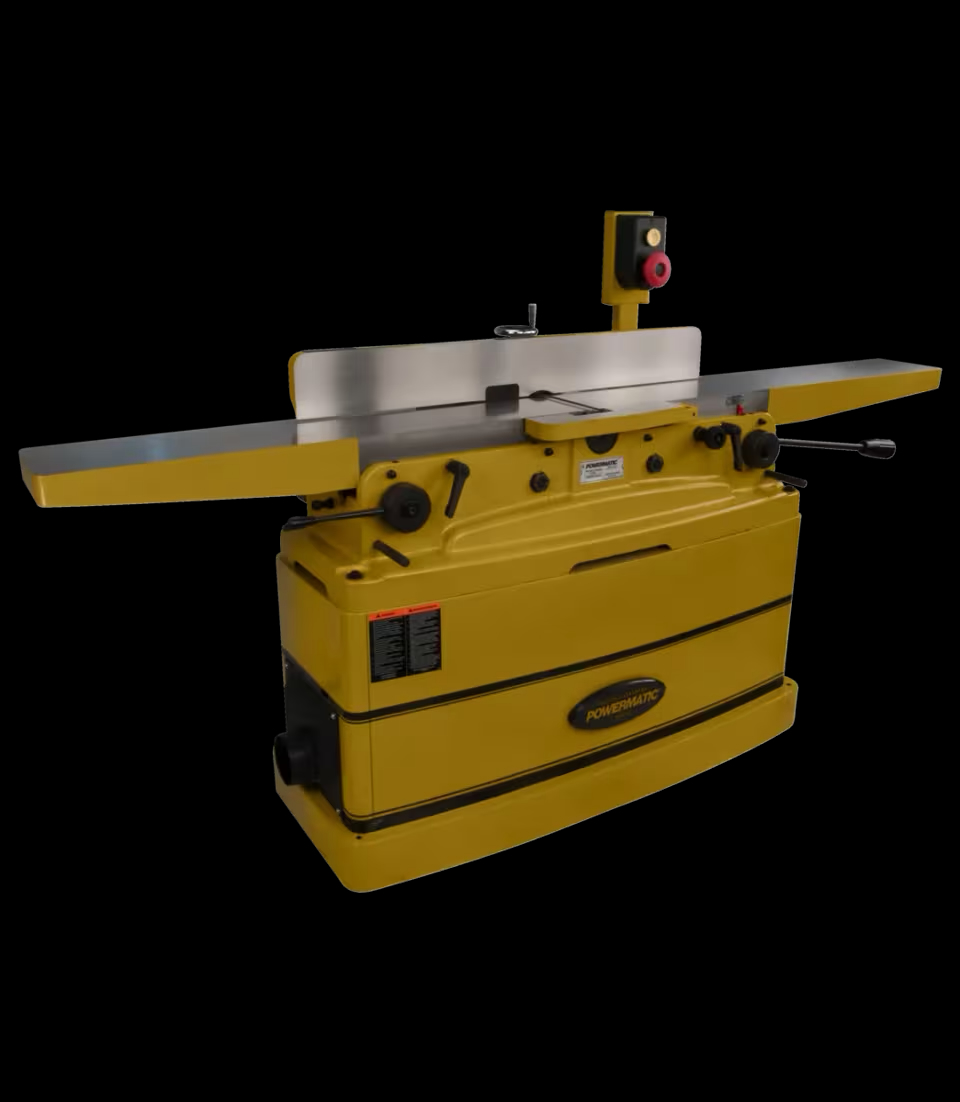Yellow industrial woodworking jointer with a long metal table, raised fence, and overhead control box, shown against a black background.