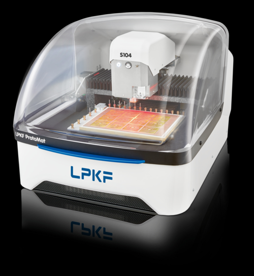 Enclosed LPKF ProtoMat circuit-board milling machine with a visible orange circuit board under its transparent cover.