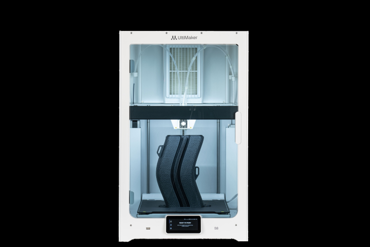 Front view of a white Ultimaker 3D printer producing two tall, curved black objects on its build plate.