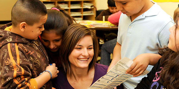 woman smiling with classmates in the Bagwell College of Education