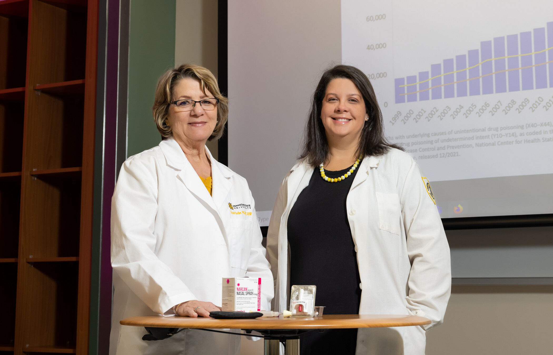 two women standing at a table