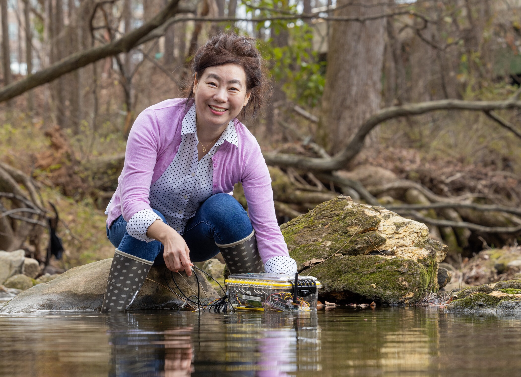 a woman using device in creek
