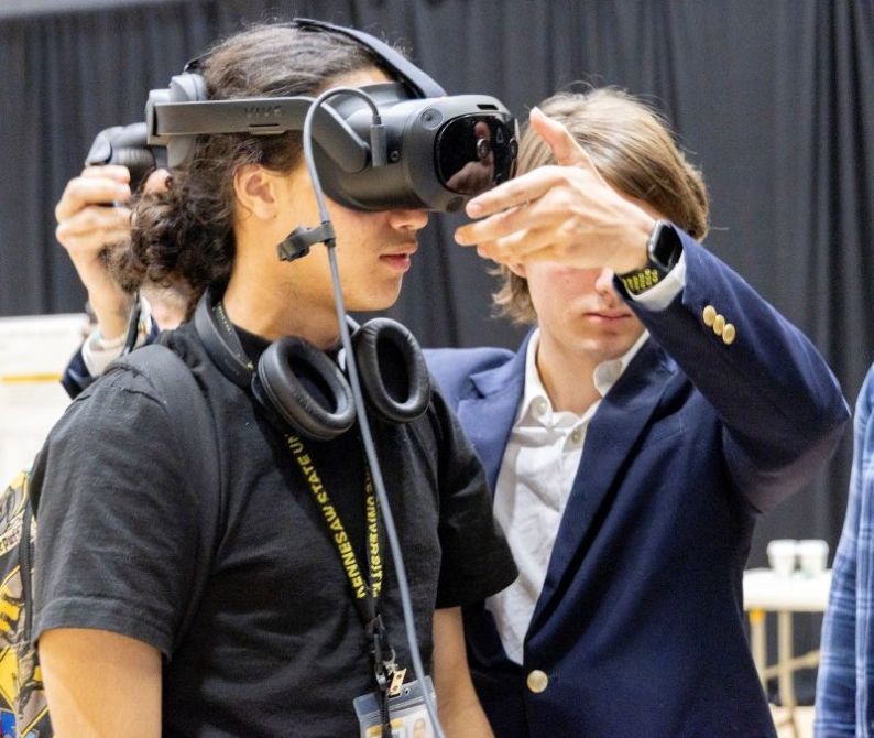 Two people interacting with a virtual reality headset