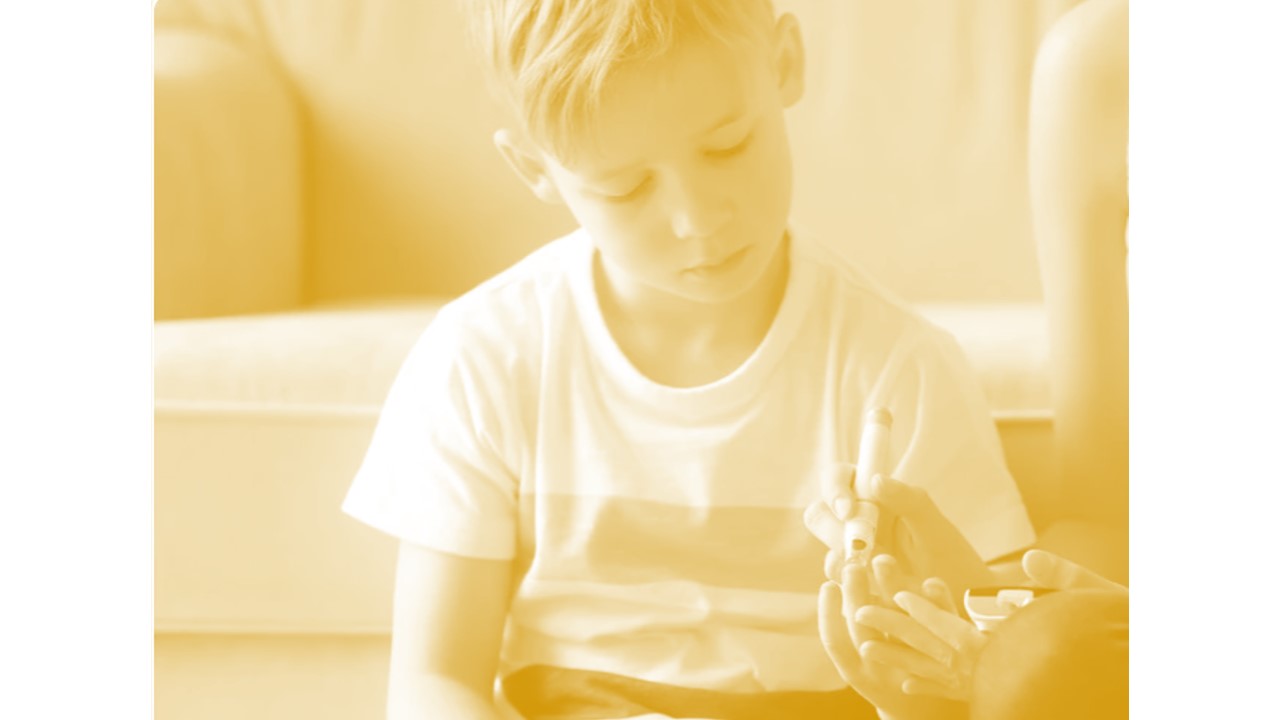 a child receiving a finger prick to check their blood-sugar level.