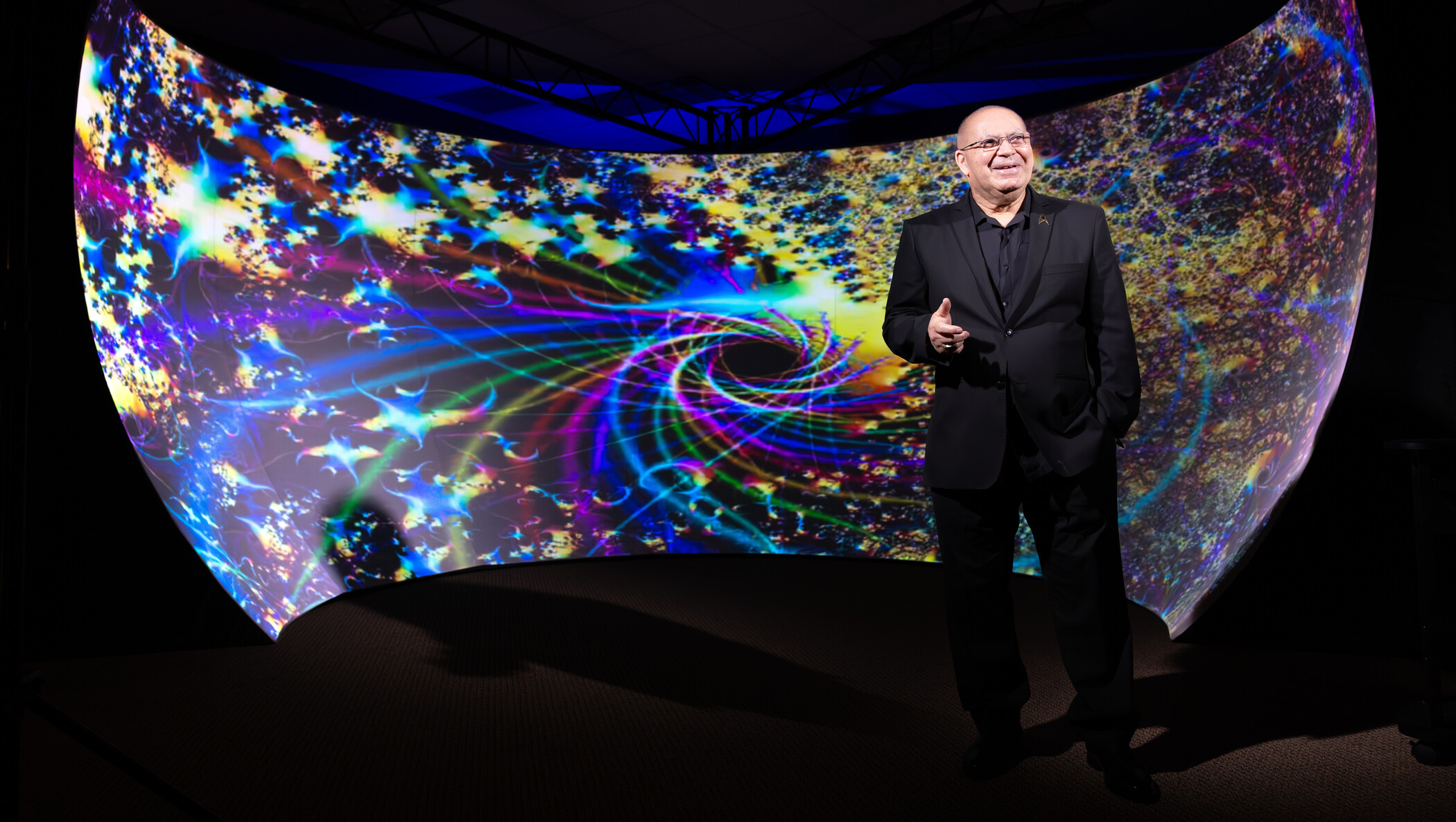 researcher standing in front of immersive screen.