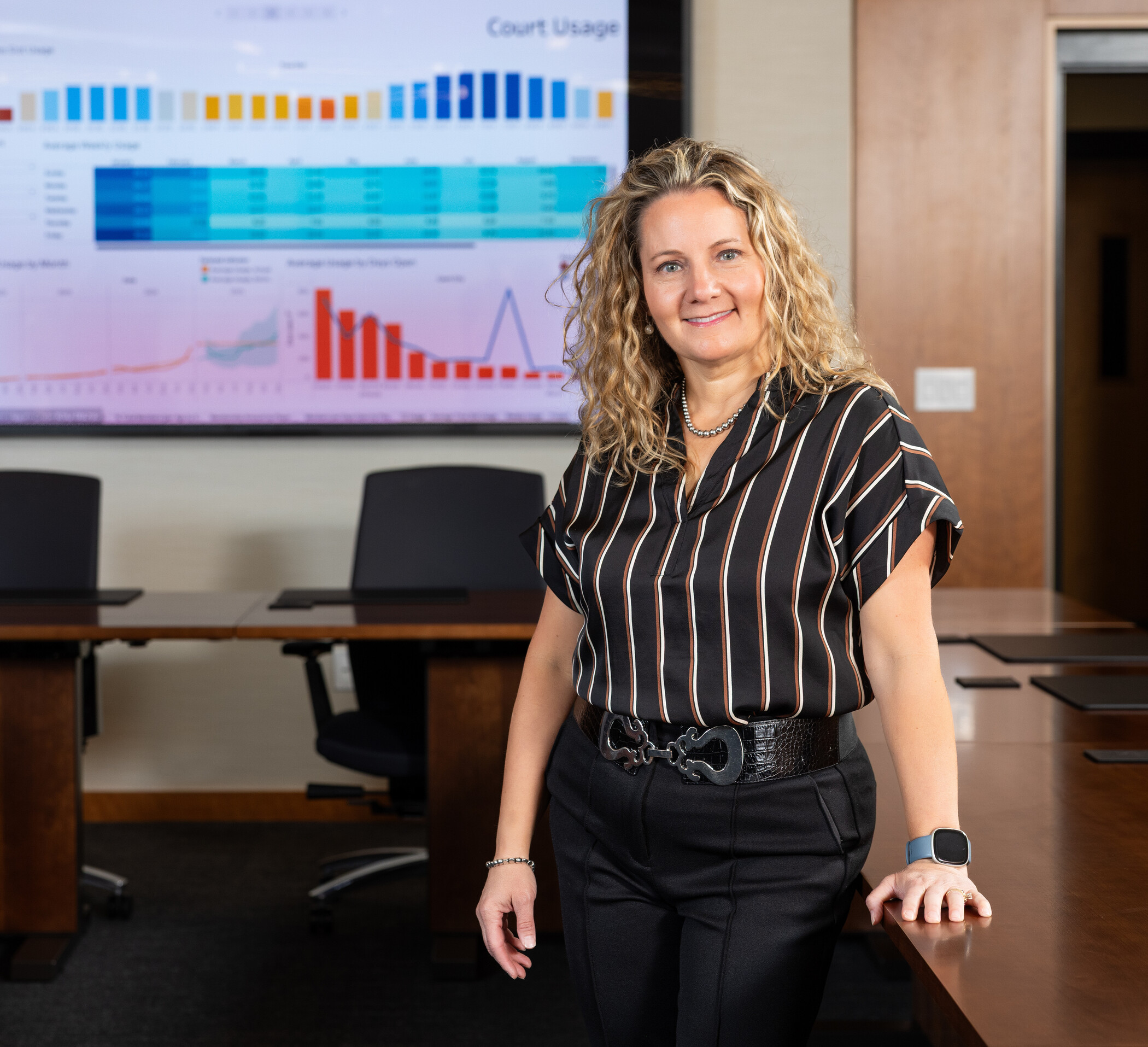 researcher leaning on table with charts in background