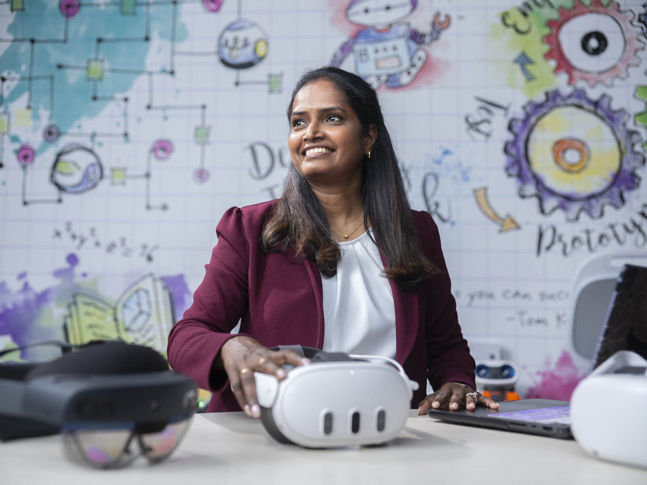 researcher sitting at table with virtual reality heaset.