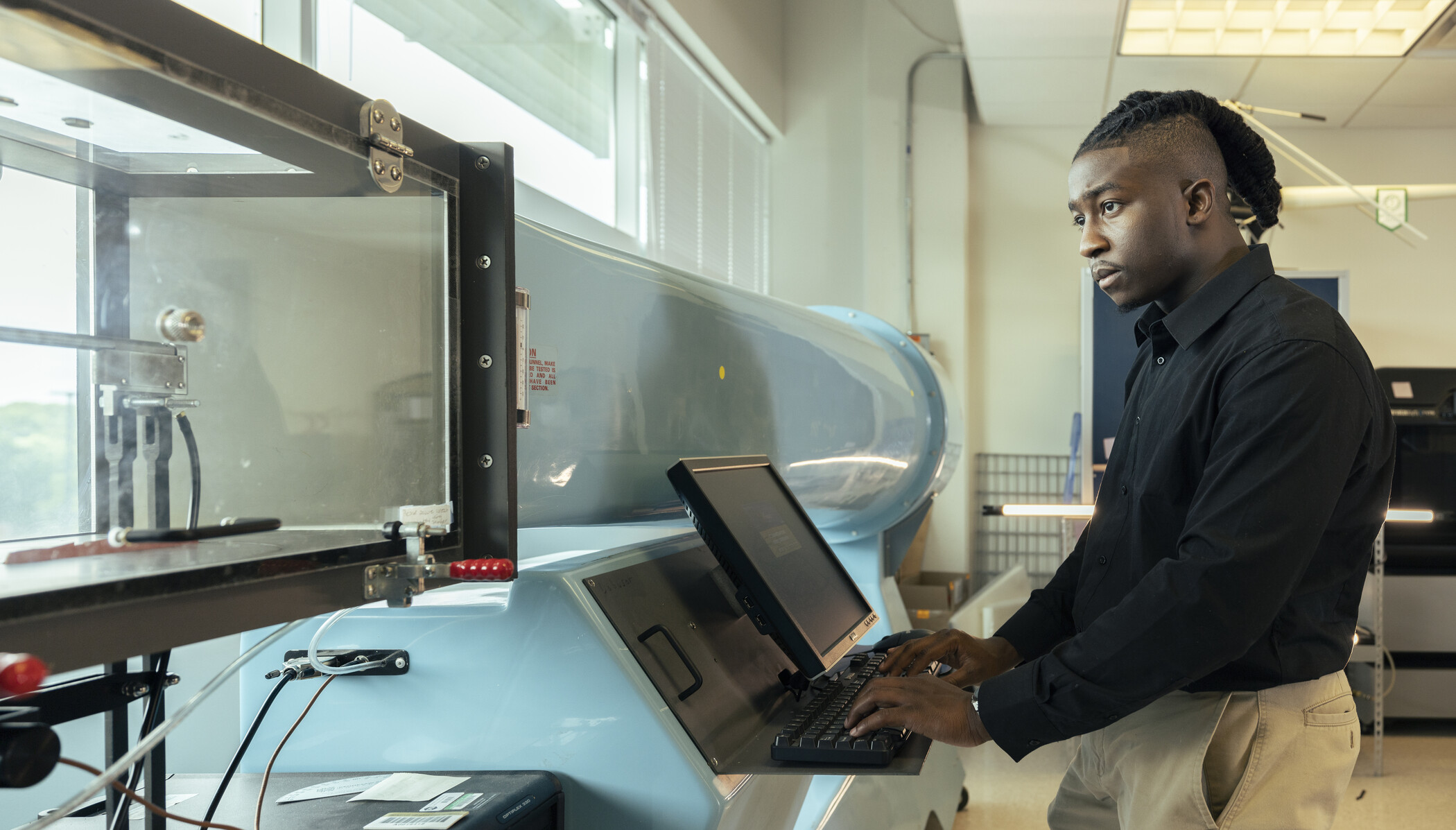 researcher testing aerospace device.