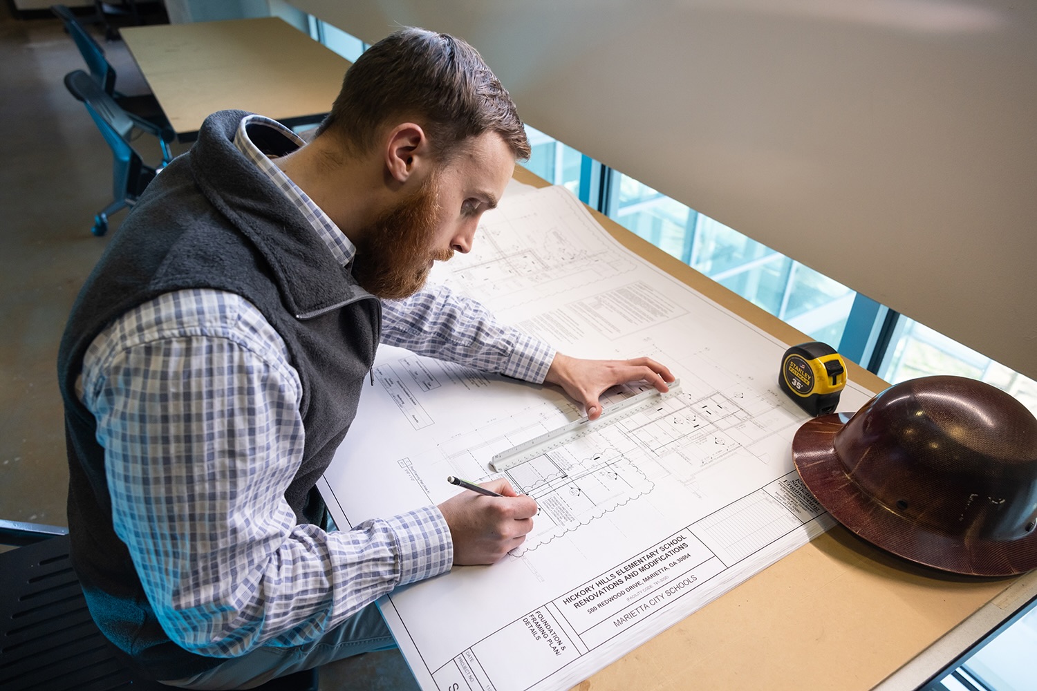 man writing on desk