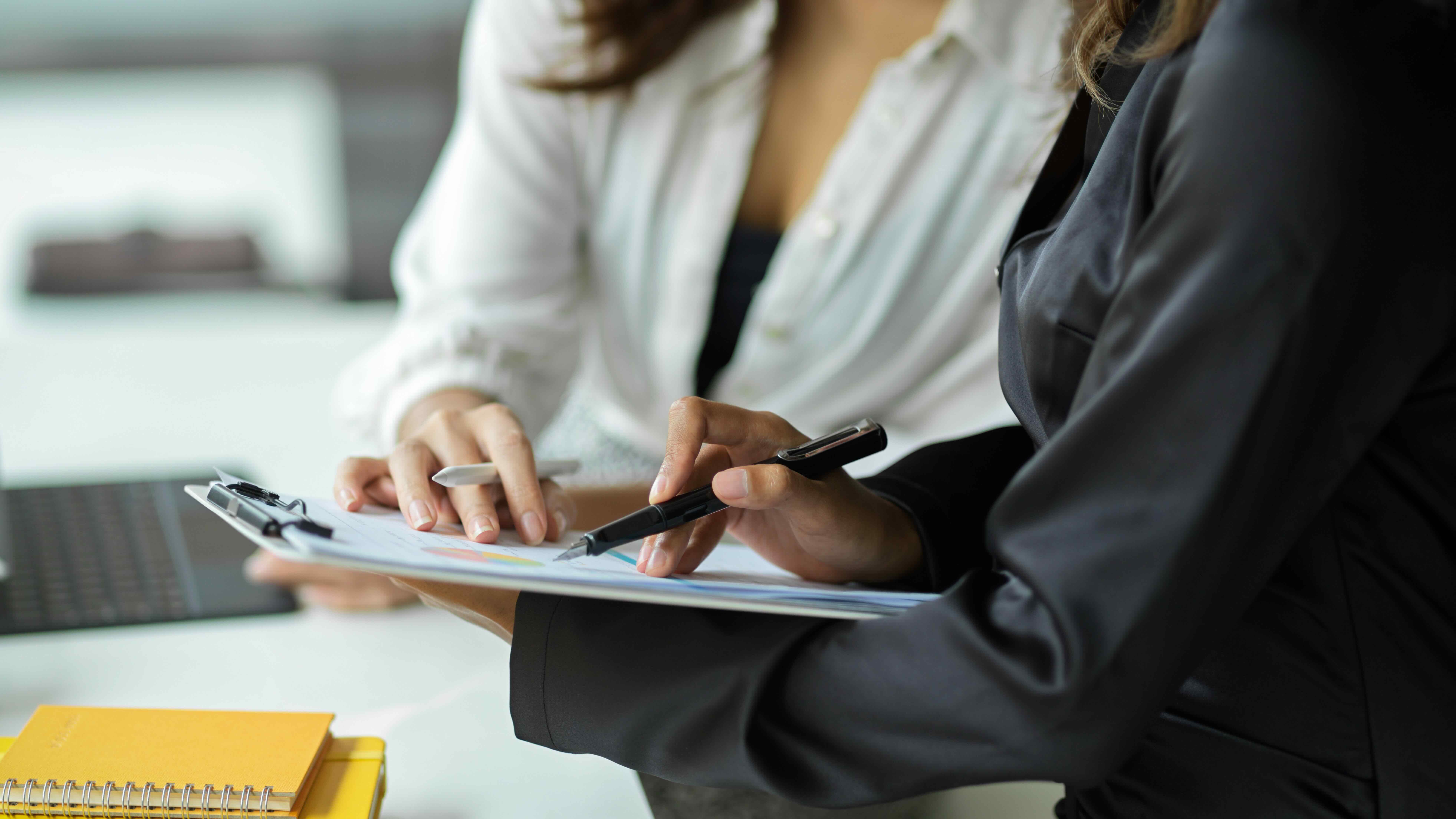 two people looking at a clipboard