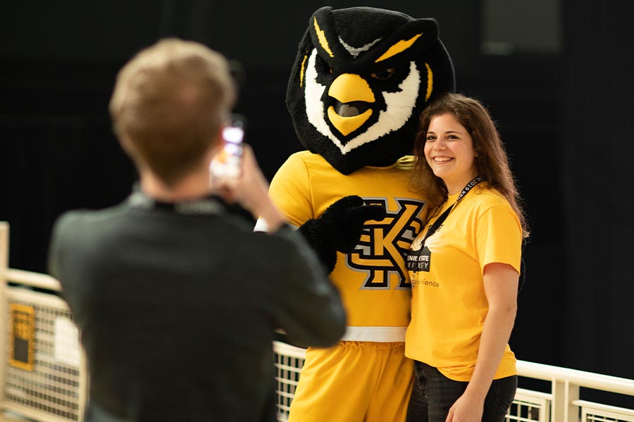 woman posing next to scrappy, ksu's mascot