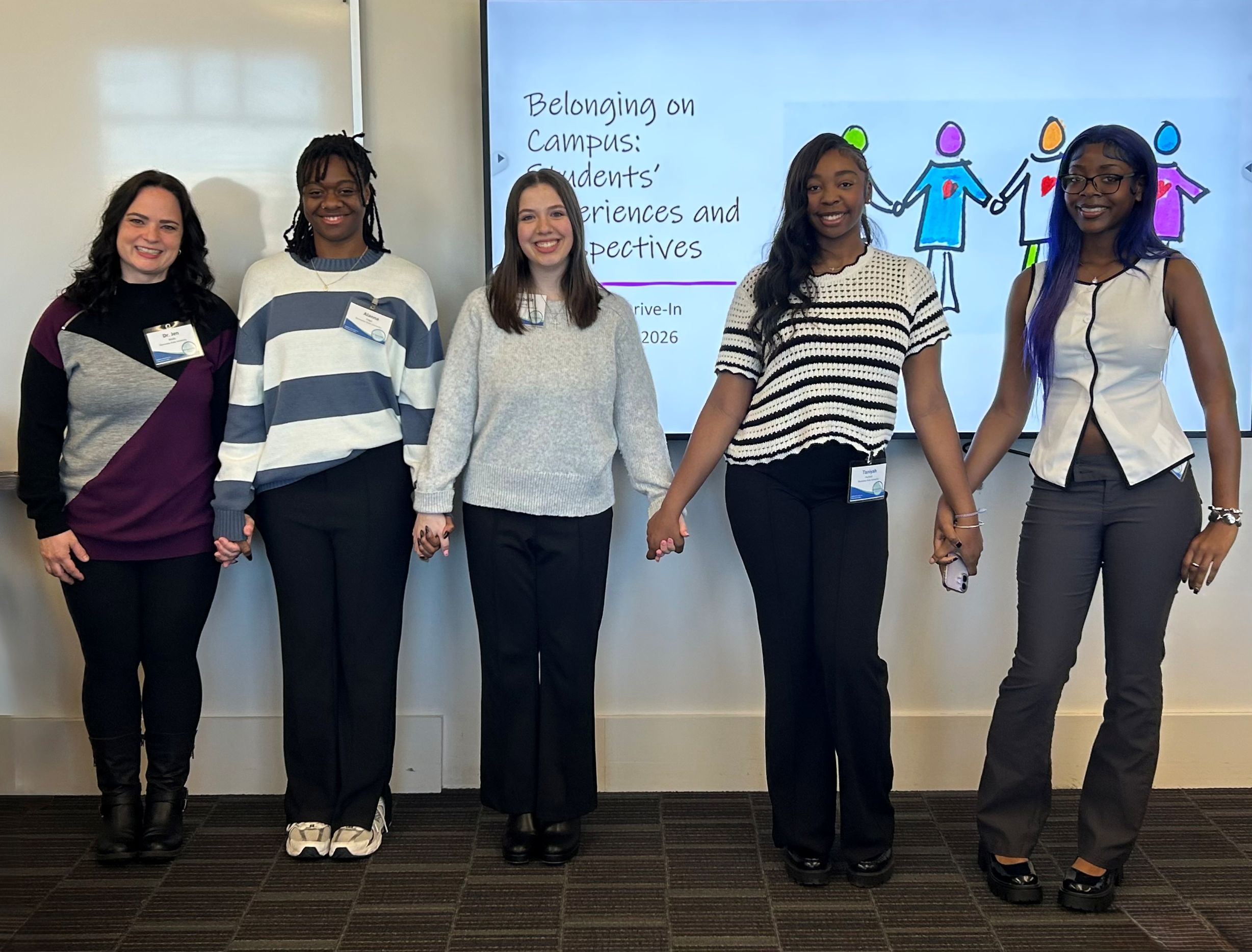 team picture of five students and faculty