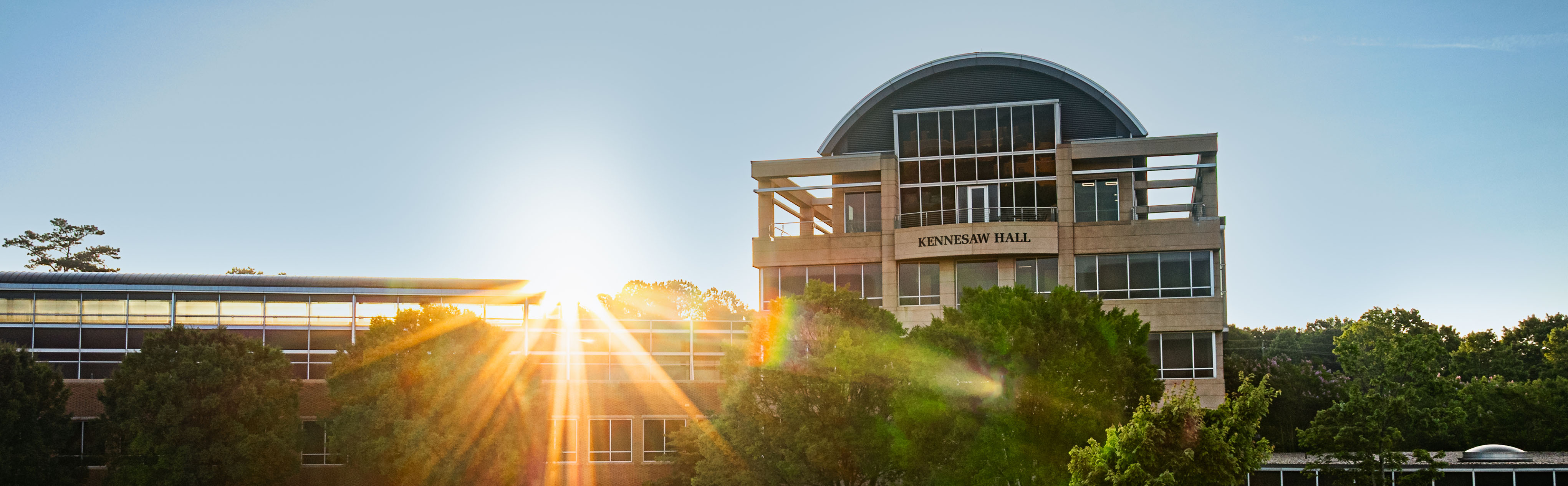kennesaw state university exterior builiding shining through golden hour lighting