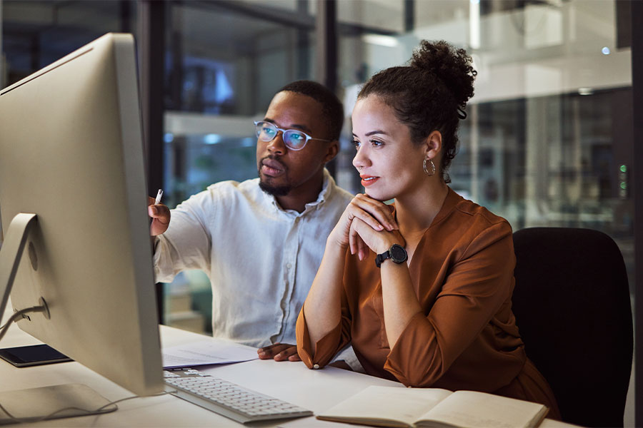 Colleagues collaborating on a computer display.