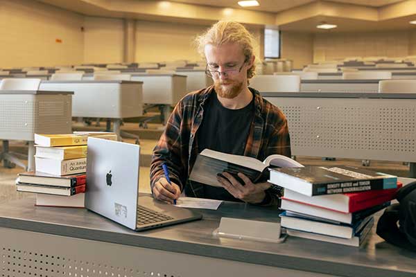 guy researching in book for web content